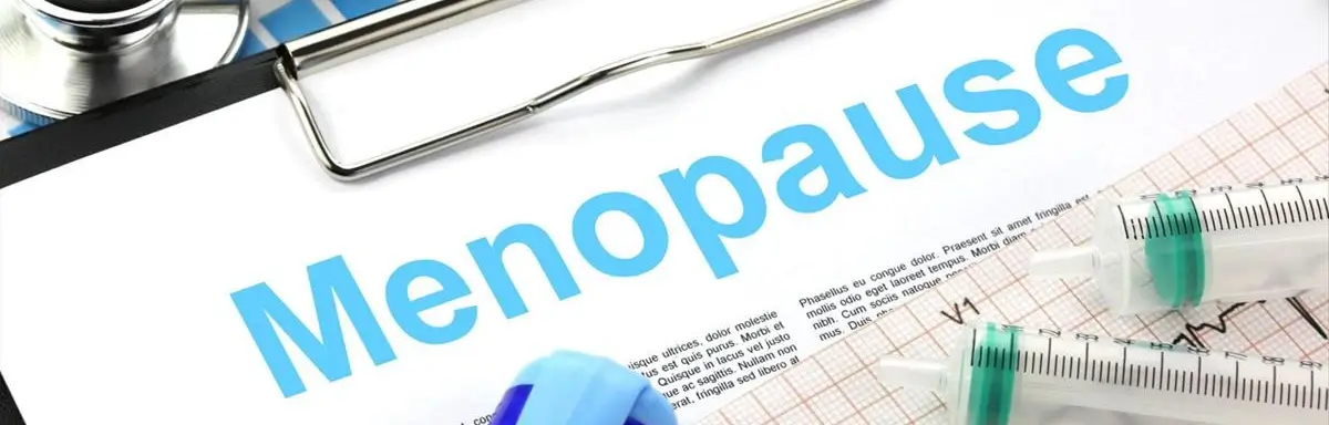 Menopause text on medical chart with stethoscope and syringes